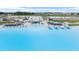 Luxurious lagoon view featuring beach cabanas, lounge chairs, boats and a beachside restaurant overlooking the clear water at 30903 Quail Caper Cir, San Antonio, FL 33576