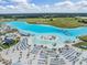 Breathtaking view of the lagoon featuring beach chairs, lounge areas, palm trees, and clear, light blue water at 30903 Quail Caper Cir, San Antonio, FL 33576