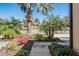 Eye-level view of a charming townhome entrance, enhanced by colorful flowers and greenery at 30903 Quail Caper Cir, San Antonio, FL 33576