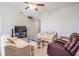 Comfortable living area with neutral walls, tile floors, and staircase access upstairs at 30903 Quail Caper Cir, San Antonio, FL 33576