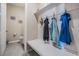 Functional mudroom with built-in bench, storage, and a convenient half-bath at 30903 Quail Caper Cir, San Antonio, FL 33576