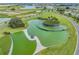 An aerial shot of a unique community park area with green spaces, water features, and lush greenery at 31616 Parkland Bay Way, San Antonio, FL 33576