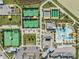 An aerial view of tennis and pickleball courts, pool and clubhouse as the centerpiece of this planned community at 31616 Parkland Bay Way, San Antonio, FL 33576