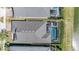 Aerial view of home with screened in pool and outdoor dining area in fenced backyard at 31616 Parkland Bay Way, San Antonio, FL 33576
