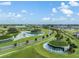 Aerial image shows water features with manicured green hills, palm trees, and winding pathways for a serene setting at 31616 Parkland Bay Way, San Antonio, FL 33576