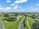 Aerial view showcases lush landscaping, water features, and manicured lawns in this picturesque community at 31616 Parkland Bay Way, San Antonio, FL 33576
