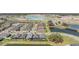 An aerial view of a neighborhood with houses, ponds, a bridge, roads, and a large aquapark at 31616 Parkland Bay Way, San Antonio, FL 33576