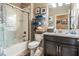 Well-maintained bathroom with a shower/tub combo, storage shelves, and a modern vanity at 31616 Parkland Bay Way, San Antonio, FL 33576