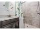 Elegant bathroom featuring a glass door shower, stylish vanity, and contemporary fixtures at 31616 Parkland Bay Way, San Antonio, FL 33576