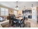 Open-concept kitchen and dining area featuring dark cabinetry and a wooden dining table at 31616 Parkland Bay Way, San Antonio, FL 33576