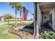 View of home's front porch with rocking chairs and an American flag hanging from the column at 31616 Parkland Bay Way, San Antonio, FL 33576