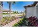 Beautifully landscaped front yard with lush plants and a brick walkway leading to a modern home at 31616 Parkland Bay Way, San Antonio, FL 33576