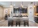 This spacious kitchen features dark cabinets, stainless steel appliances, and an island with bar seating at 31616 Parkland Bay Way, San Antonio, FL 33576