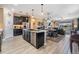 Spacious kitchen with an island, dark cabinetry, and open layout to the living and dining areas at 31616 Parkland Bay Way, San Antonio, FL 33576