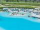 Aerial view of a community lagoon with water slides, beach area, lounge chairs, and waterfront amenities at 31616 Parkland Bay Way, San Antonio, FL 33576