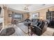 Comfortable living room with tile floors, modern furnishings, and a sliding glass door to the outdoor patio at 31616 Parkland Bay Way, San Antonio, FL 33576