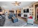Open-concept living room with a fireplace, built-in shelving, and views of the kitchen at 31616 Parkland Bay Way, San Antonio, FL 33576