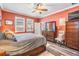 The primary bedroom boasts warm colors, wood-look floors, and plenty of natural light at 31616 Parkland Bay Way, San Antonio, FL 33576