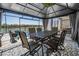 Covered outdoor patio with a dining set, overlooking a pool and a tranquil lake at 31616 Parkland Bay Way, San Antonio, FL 33576