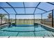 Sparkling pool with a screened enclosure and a view of the surrounding neighborhood at 31616 Parkland Bay Way, San Antonio, FL 33576