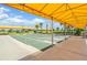 Shuffleboard courts under a bright yellow awning, offering shaded outdoor recreation at 31616 Parkland Bay Way, San Antonio, FL 33576