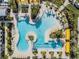 Aerial view of a resort-style community pool with lounge chairs, palm trees, and cabanas at 31616 Parkland Bay Way, San Antonio, FL 33576