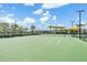 Expansive tennis court area with lush greenery, featuring well-maintained courts and a covered seating area at 31616 Parkland Bay Way, San Antonio, FL 33576