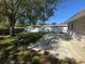 Backyard showcasing the concrete patio, partial view of the fence and greenery at 410 42Nd Ne Ave, St Petersburg, FL 33703