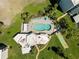 Aerial of community pool, shuffleboard courts, clubhouse, and surrounding green spaces at 4210 Ironwood Cir # 501J, Bradenton, FL 34209