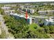 Overhead of the building with red arrow and surrounding trees, parking and golf course views at 4210 Ironwood Cir # 501J, Bradenton, FL 34209
