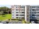 Multi-story building with balconies, stone accents, and well-maintained landscaping near a parking area at 4210 Ironwood Cir # 501J, Bradenton, FL 34209