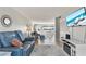Bright living room featuring tile floors, modern decor, and a comfortable blue leather sofa at 4210 Ironwood Cir # 501J, Bradenton, FL 34209