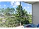 Screened-in patio offers stunning views of lush greenery and clear blue skies at 4210 Ironwood Cir # 501J, Bradenton, FL 34209