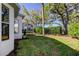 Landscaped backyard features a fenced yard and mature trees providing shade and privacy at 4702 Corsage Dr, Lutz, FL 33558