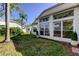 Backyard features well-maintained lawn and exterior windows at 4702 Corsage Dr, Lutz, FL 33558