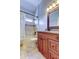Bathroom featuring a vanity with a granite countertop and a tub with shower at 4702 Corsage Dr, Lutz, FL 33558