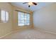 Bright bedroom featuring carpet, a ceiling fan and natural light from the windows at 4702 Corsage Dr, Lutz, FL 33558