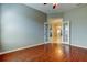 Bedroom with laminate flooring and open view into adjacent rooms at 4702 Corsage Dr, Lutz, FL 33558