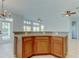 Bright, tiled dining space with natural wood cabinets, light countertops, and chandelier lighting at 4702 Corsage Dr, Lutz, FL 33558