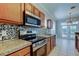 Kitchen with stainless steel appliances, granite counters, tile backsplash at 4702 Corsage Dr, Lutz, FL 33558