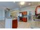 Open kitchen with stainless steel appliances, breakfast bar, tile backsplash and chandelier at 4702 Corsage Dr, Lutz, FL 33558