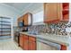 Kitchen featuring stainless appliances, granite counters, and tile backsplash at 4702 Corsage Dr, Lutz, FL 33558