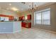 Kitchen with stainless steel appliances, tile backsplash and chandelier at 4702 Corsage Dr, Lutz, FL 33558