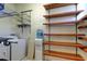 Laundry room includes shelving, washer, dryer and water cooler at 4702 Corsage Dr, Lutz, FL 33558