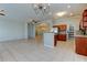 Open concept with tile floors, stainless appliances and an adjoined dining area at 4702 Corsage Dr, Lutz, FL 33558