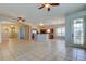 Expansive living room with tile flooring, chandeliers, ceiling fans and plenty of room for entertaining at 4702 Corsage Dr, Lutz, FL 33558