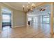 Large living room with tile flooring, chandelier, ceiling fans and an open floor plan at 4702 Corsage Dr, Lutz, FL 33558