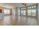Bright living room features large windows and shutters, chandelier and ceiling fan at 4702 Corsage Dr, Lutz, FL 33558