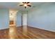 Spacious main bedroom with hardwood floors and a ceiling fan at 4702 Corsage Dr, Lutz, FL 33558