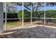 A screened patio featuring brick pavers and privacy landscaping at 4702 Corsage Dr, Lutz, FL 33558